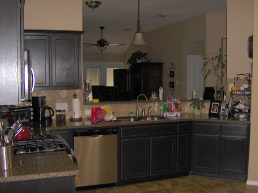 Detail of Kitchen Cabinets painted satin black then antiqued and distressed.