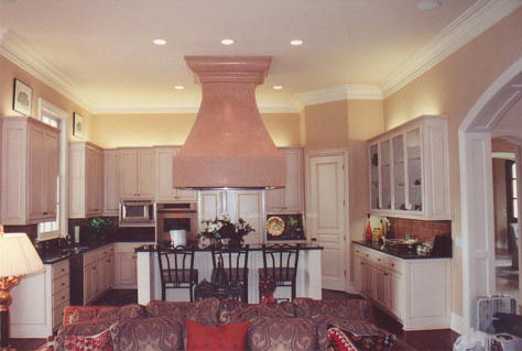 Antiqued kitchen cabinets and faux painting vent hood